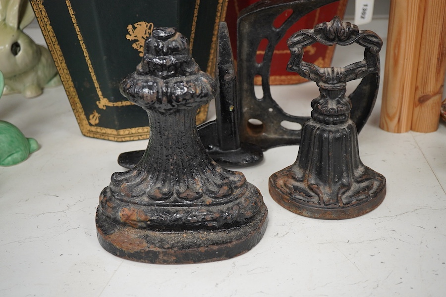 Two Italian gilt tooled leather waste paper baskets together with two Victorian cast iron doorstops and two boot scrapers, largest 29cm high